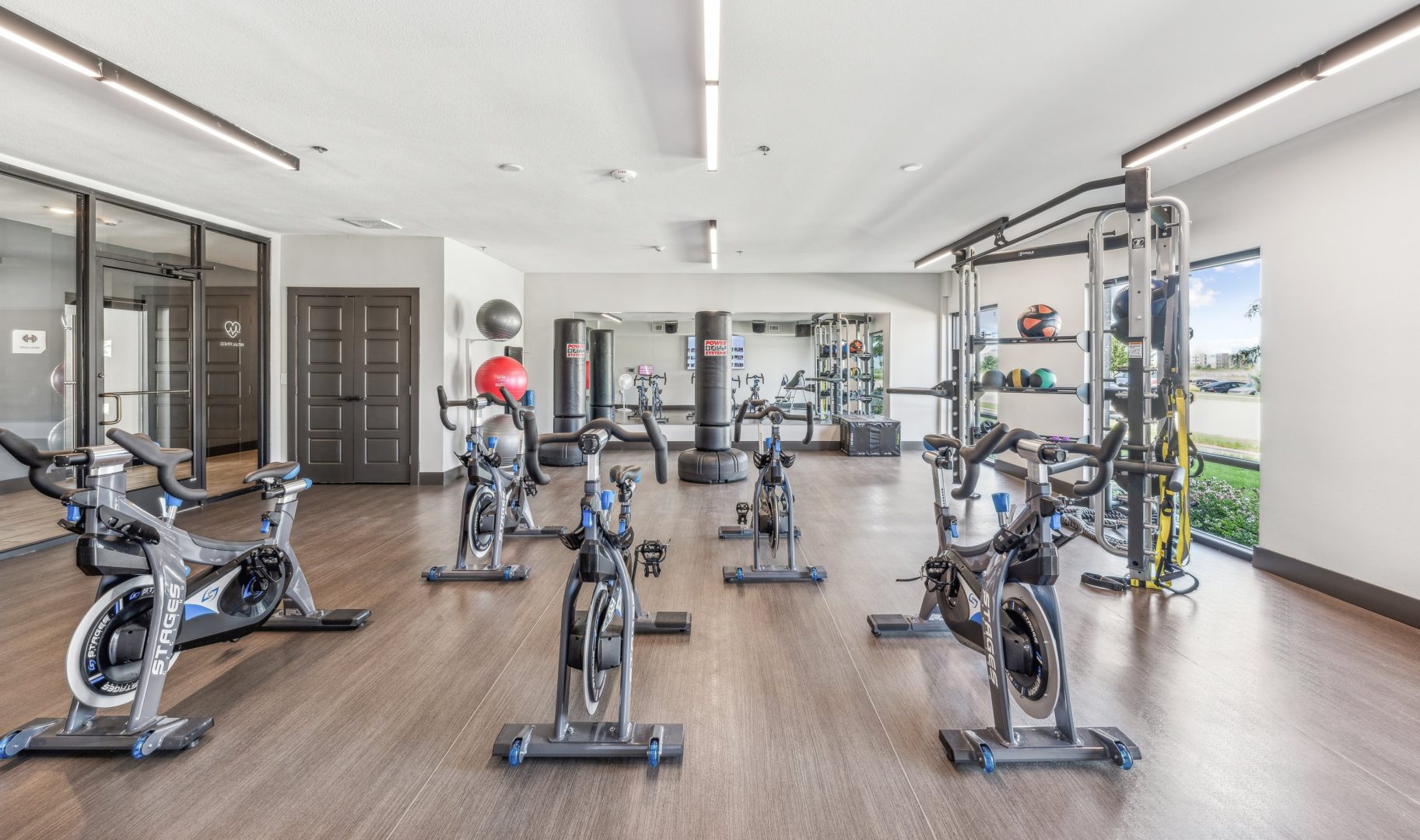 a gym room with exercise bikes and mirrors at The Terra at University North Park