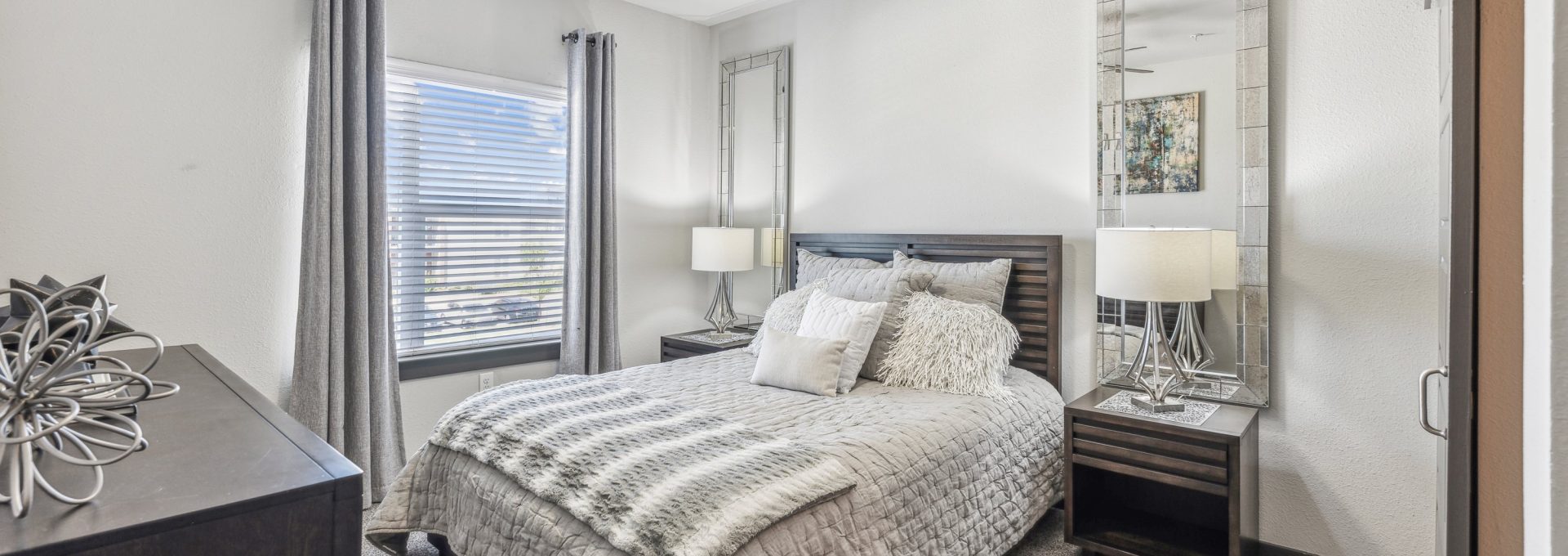 a bedroom with a ceiling fan and a large bed at The Terra at University North Park