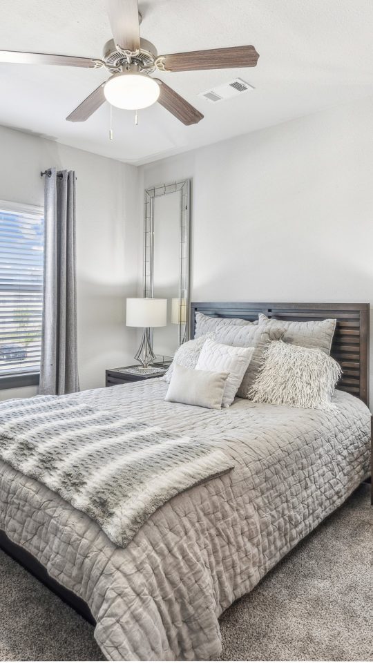 a bedroom with a ceiling fan and a large bed at The Terra at University North Park